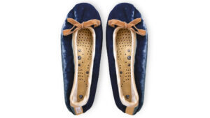 A flat image of a pair of Holistic Silk ballerina style Massaging Slippers in a Navy Silk Velvet colour with a honey colour velvet bow tie at the top edge of the toe area. The slippers are side by side with the toes at the top of the image. The magentic insoles inside the slippers are visable.