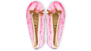 A flat image of a pair of Holistic Silk ballerina style Massaging Slippers in a Rose Silk Velvet colour with a honey colour velvet bow tie at the top edge of the toe area. The slippers are side by side with the toes at the top of the image. The magentic insoles inside the slippers are visable.