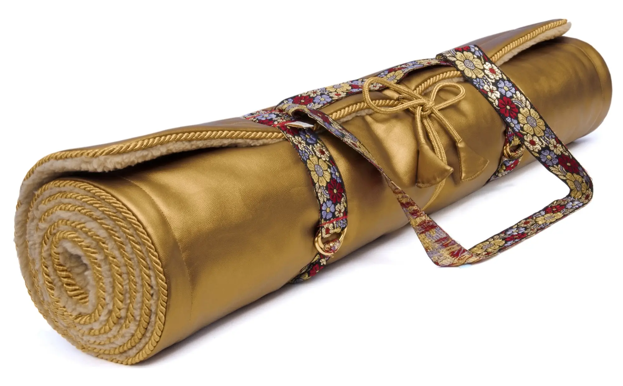A rolled gold-colored yoga mat secured with floral-patterned straps and decorative gold cord ties, resting on a white background.