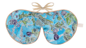 Flat image of the Holistic Silk Excluisve Silk Sleep Mask with a watercolour effect hand drawn Fig Tree design with Honey colour piping and a Honey colour velvet bow above it on a clear white background.