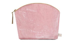 A flat image of the Holistic Silk Lavender Make Up Bag in Rose Silk Velvet.The make up bag is stood up and is wider at the top than the bottom, it has a curved zipped top which has a honey colour piping outlining it and the zip pull hanging to the top left of the bag.
