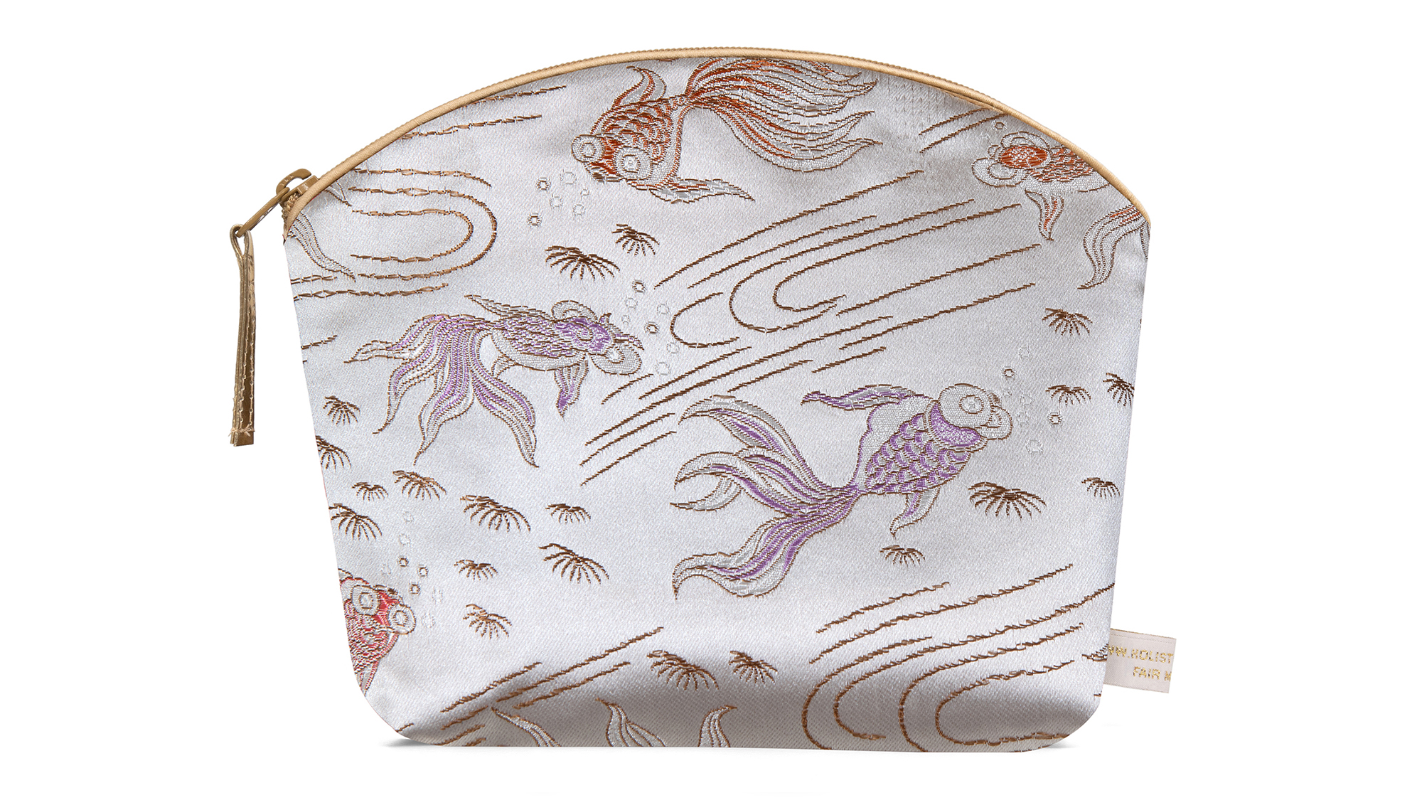 A flat image of the Holistic Silk Lavender Make Up Bag in a Silver Fish Brocade on a white background. The design shows pink colour abstract koi carp on a silver background. The wash bag is stood up and is wider at the top than the bottom, it has a curved zipped top which has a honey colour piping outlining it and the zip pull hanging to the top left of the bag.