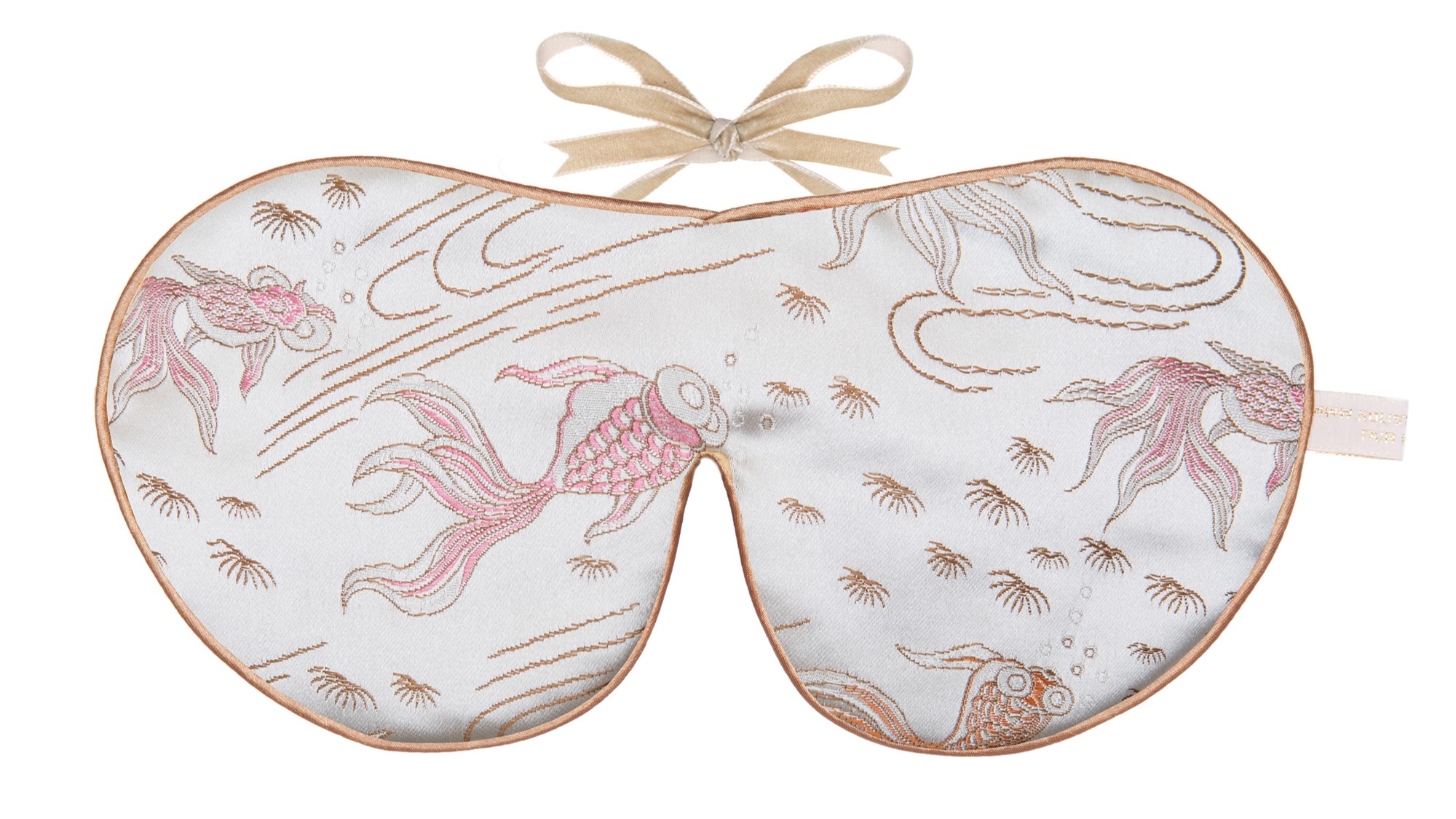 Flat image of the Holistic Silk Limited Edition Brocade Sleep Mask in a Silver Fish design featuring pink colour koi carp on a silver beackround with Honey colour piping and a Honey colour velvet bow above it on a clear white background.