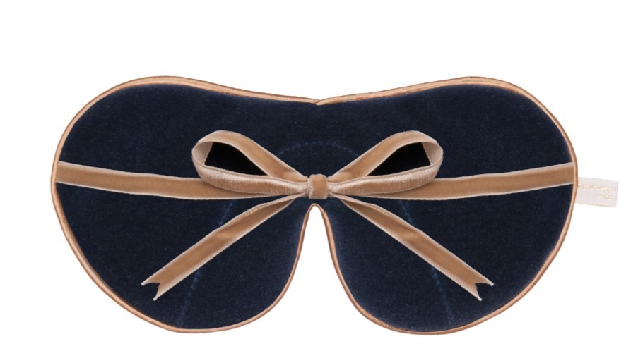 Flat image of the reverse of the Holistic Silk Limited Edition & Silk Velvet Sleep Masks showing the Navy reverse, Honey colour piping and the Honey colour velvet bow tied and sitting across the middle of the mask.