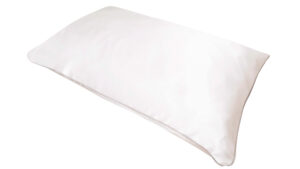 A flat image of the Holistic Silk Pillowcase in White Mulberry Silk laid diagonally across the shot showing the white coloured piping.