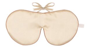 Flat image of the Holistic Silk Classic Silk Sleep Mask in a Cream colour with Honey colour piping and a Honey colour velvet bow above it on a clear white background.