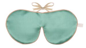 Flat image of the Holistic Silk Classic Silk Sleep Mask in a Jade colour with Honey colour piping and a Honey colour velvet bow above it on a clear white background.