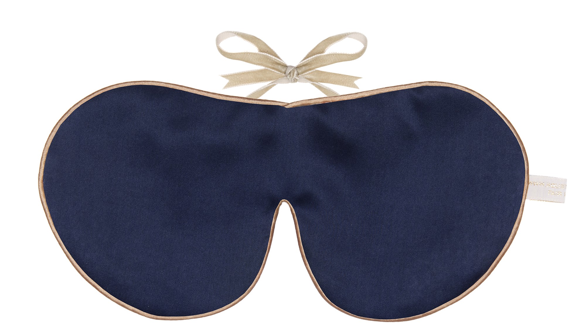 Flat image of the Holistic Silk Classic Silk Sleep Mask in a Navy colour with Honey colour piping and a Honey colour velvet bow above it on a clear white background.