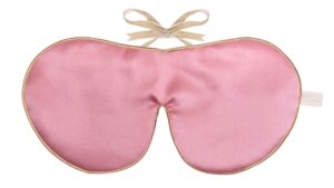 Flat image of the Holistic Silk Classic Silk Sleep Mask in a Rosecolour with Honey colour piping and a Honey colour velvet bow above it on a clear white background.