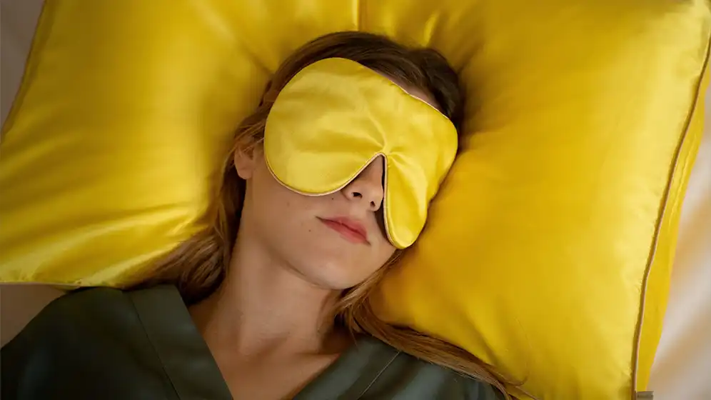 Sundrop Yellow Silk Sleep Mask on Silk Pillow – Lifestyle Image | Holistic Silk