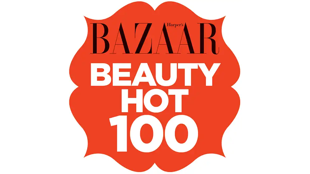 Harper’s Bazaar Beauty Hot 100 badge in bold coral with white text and scalloped edges