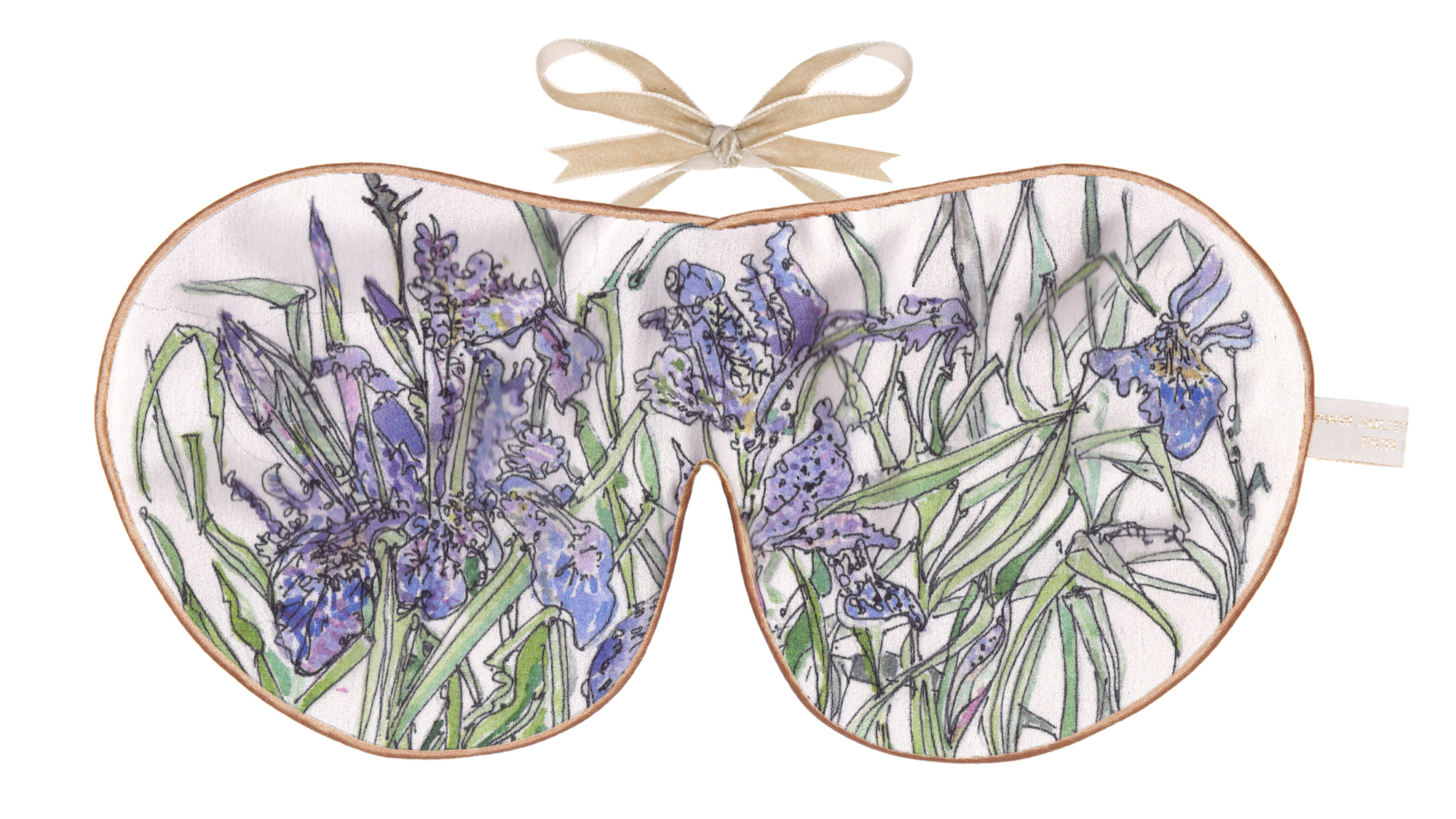 Silk sleep mask with illustrated violet irises and long green leaves on a light background.