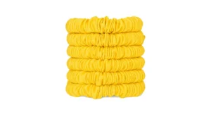 A stack of skinny silk scrunchies in a Sundrop Yellow shade, neatly arranged to show their smooth gathered texture