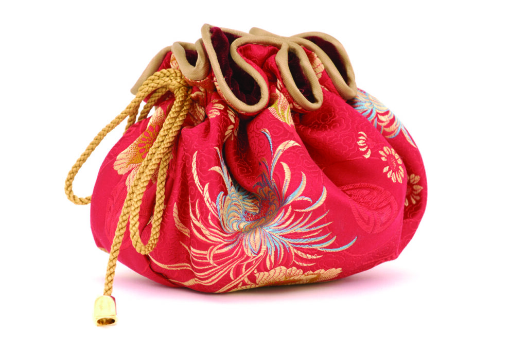 A red brocade drawstring jewellery pouch with gold cord and floral embroidered detailing