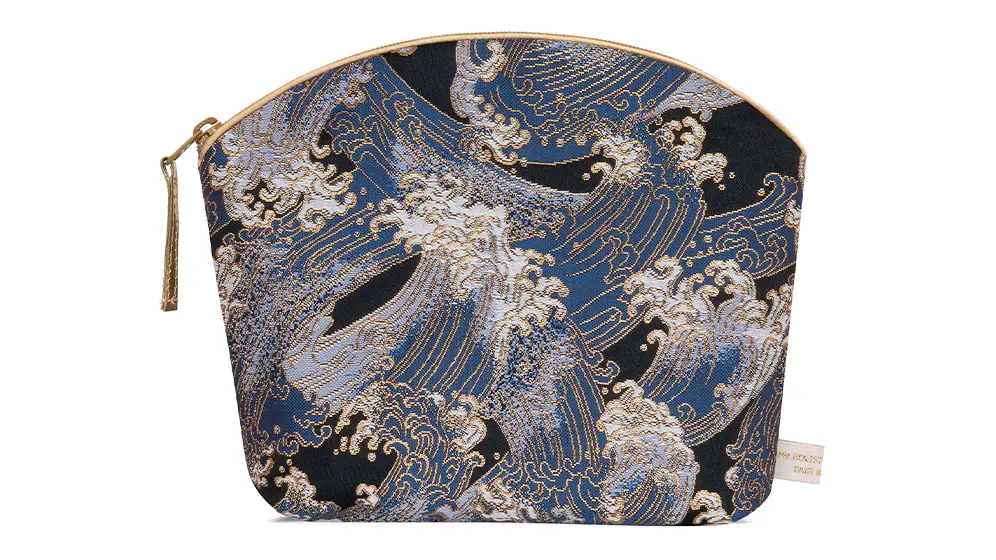 Navy blue make up bag with intricate Japanese wave pattern and honey coloured piping and tassel zip