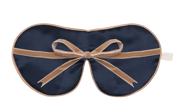 Flat image of the reverse of the Holistic Silk Classic, Unscented & Exclusive Silk Sleep Masks showing the Navy reverse, Honey colour piping and the Honey colour velvet bow tied and sitting across the middle of the mask.
